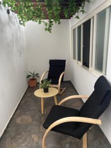 a room with two chairs and a table at Hotel Arrendajo in Acacías