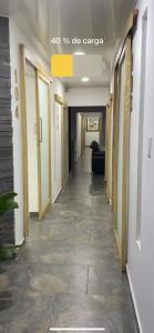 a hallway of an office building with a long corridor at Hotel Arrendajo in Acacías