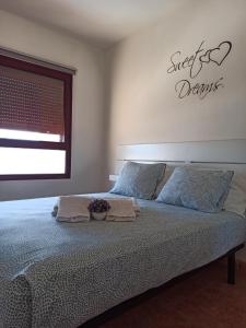 a bedroom with a bed with two towels on it at Bahia Sol Dream -Caleta de Fuste- in Caleta De Fuste