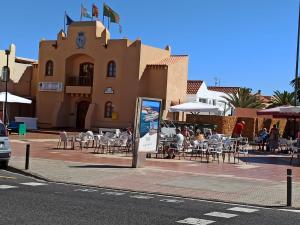 un gruppo di persone seduti ai tavoli di fronte a un edificio di Bahia Sol Dream -Caleta de Fuste- a Caleta De Fuste Altre 10 foto