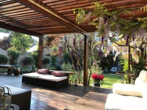 a patio with a couch and a pergola at LondonHomeGardens in London
