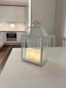 a glass container with candles on a kitchen counter at Pallace House in Oslo