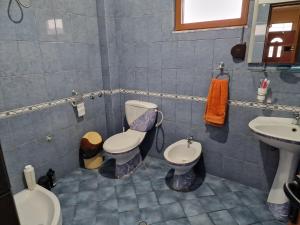 a bathroom with two toilets and a sink at vila dhimo in Fier