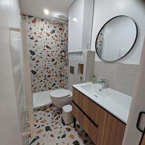 a bathroom with a toilet and a sink and a mirror at Serenity Indepedent Suite near to Disneyland & Paris in Bussy-Saint-Georges