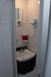 a bathroom with a sink and a hair dryer at Casa Salazar Guadalajara in Guadalajara