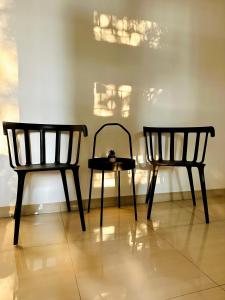 two chairs and a table in a room at 4-Bedroom Home in South Jakarta Nuansa Swadarma Residence by Le Ciel Hospitality in Jakarta