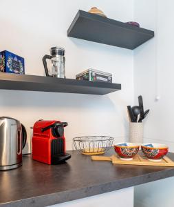 a kitchen counter with a red toaster and bowls at Annecy Lake Central in Annecy