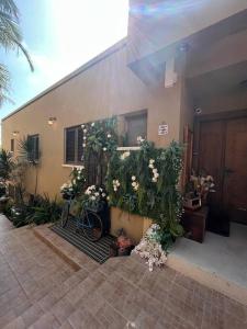 a building with a bunch of plants and flowers at Laethos - the house of fun. in Kfar Yona