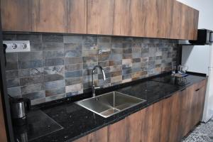 a kitchen with a sink and a black counter top at Sevilla Industrial Flat in Seville