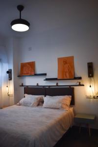a bedroom with a large bed with two pillows at Sevilla Industrial Flat in Seville
