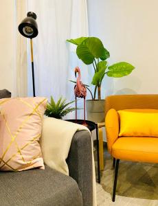a living room with two chairs and a flamingo statue at CHIC CENTRO MALASAÑA in Madrid