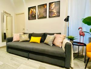a living room with a couch with colorful pillows at CHIC CENTRO MALASAÑA in Madrid