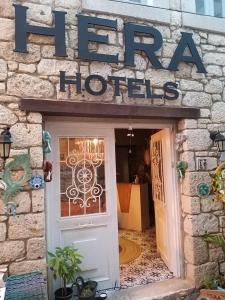a door to a hotel with a sign above it at Hera Hotels Alaçatı in Cesme