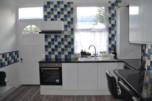 a kitchen with a sink and a window at Luxury Home Close to Leeds City Centre in Leeds