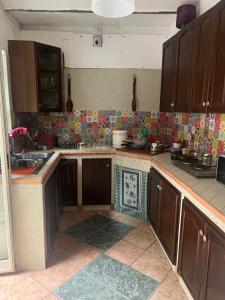 a kitchen with wooden cabinets and a counter top at Coremi in Naples