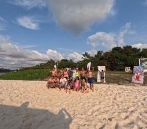 een groep mensen die poseren voor een foto op het strand bij URREAHOUSE IQUITOS in Iquitos