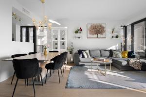 a living room with a table and a couch at Luxurious 2BR apartment at Central OSLO BARCODE in Oslo