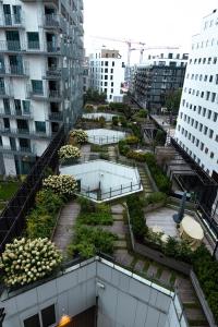a building with a garden on the side of it at Spacious modern 2BR apartment at Central OSLO BARCODE in Oslo
