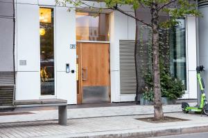 a building with a wooden door on a street at Spacious modern 2BR apartment at Central OSLO BARCODE in Oslo