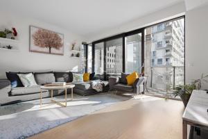 a living room with a couch and a table at Spacious modern 2BR apartment at Central OSLO BARCODE in Oslo