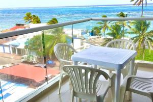 a balcony with a table and chairs and the ocean at Sea View 603B in San Andrés