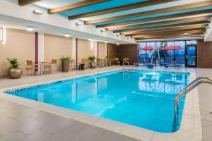 a pool with blue water in a hotel room at Home2 Suites by Hilton Buffalo Airport/ Galleria Mall in Cheektowaga