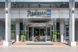 an entrance to a building with a sign on it at Radisson Blu Latvija Conference & Spa Hotel, Riga in Rīga