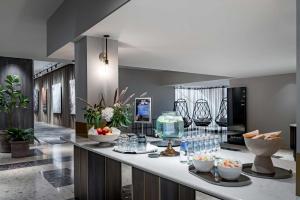 a kitchen with a counter with drinks and glasses on it at Radisson Blu Latvija Conference & Spa Hotel, Riga in Rīga