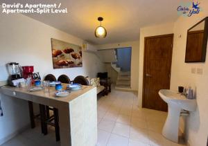 a kitchen and living room with a counter and a sink at Casa de Yoli in Cozumel +36 photos