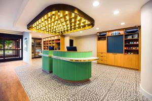 a lobby with a green bar with lights on it at Sonesta Select Philadelphia Airport in Philadelphia