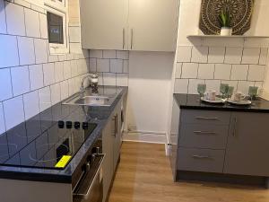 a kitchen with a sink and a counter top at De Luxe Apartment in Leicester