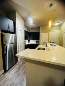 a kitchen with a sink and a refrigerator at Check me out! in Dallas