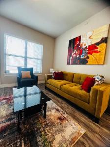 a living room with a couch and a chair at Check me out! in Dallas