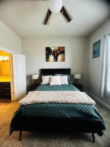 a bedroom with a large bed with a ceiling fan at Check me out! in Dallas