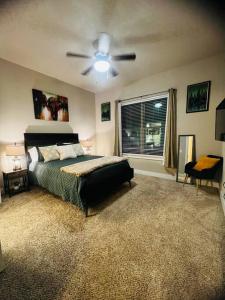 a bedroom with a bed and a ceiling fan at Check me out! in Dallas