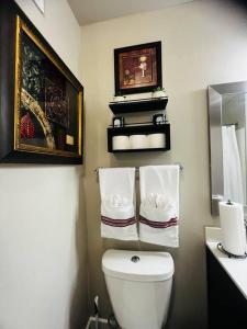 a bathroom with a toilet and a sink with towels at Check me out! in Dallas