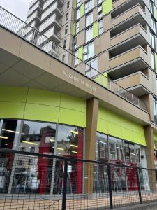 a building with a fence in front of it at Wembley Stadium Luxurious Apartment in London