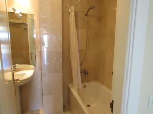 a bathroom with a shower and a toilet and a sink at Home4Holidays in Nerja +37 photos