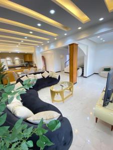 a large living room with a couch and a table at فيلا مارينا 4 الساحل الشمالي in El Alamein