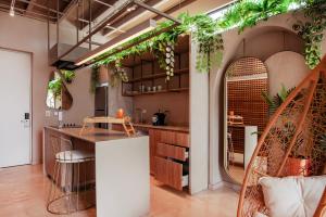 a kitchen with lots of plants on the wall at Hemma Bogotá Country Luxury Suites Hotel in Bogotá