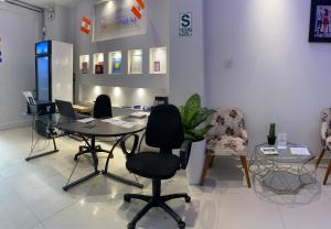 une salle d'attente avec des chaises et des tables dans un magasin dans l'établissement Millennium Hotel, à San Vicente de Cañete