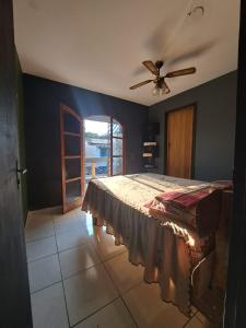 a bedroom with a bed and a ceiling fan at RustiCidade in São Paulo