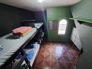a room with two bunk beds and a green wall at RustiCidade in São Paulo
