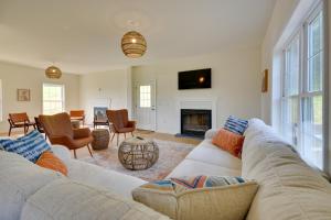 a living room with a couch and a fireplace at Timeless Hillsville Farmhouse Blue Ridge Parkway! in Ararat