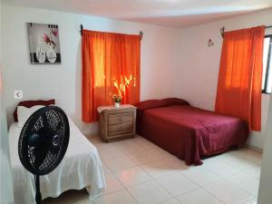 a bedroom with a bed and a fan in it at 3 bedroom 3 bath. Air Conditioner in Room 1 y 3. in Santa Cruz de Barahona