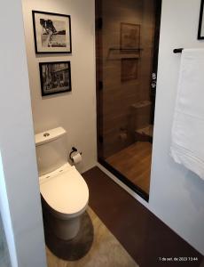 a bathroom with a toilet and a shower at Suites nas Nuvens Premium in Gramado