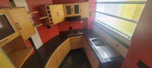 a small kitchen with a sink and a window at Hotel Naisca 47 in Pasto
