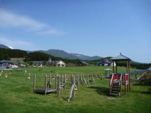 a field with a bunch of playground equipment at Awone Shirakami Juniko in Fukaura