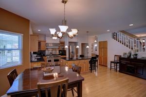 a kitchen and dining room with a table and chairs at Grand Melemele home in Pepeekeo