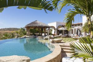 a swimming pool with a gazebo and a house at Casa Mar in El Tule